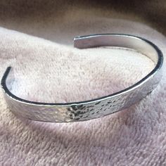 Our beautiful textured aluminium adjustable bracelets are the perfect gift for anyone, either to send as a gift or keep for yourself. These bangles are lightweight and come in a choice of three thicknesses.  The bangles can be gently bent to fit any size wrist by pinching the ends together.  The bangles are unique as they are made just for you! - making a statement while still being versatile enough to go with any outfit. We handcraft every product to order and aim to have it ready to within 3 t Adjustable Silver Stainless Steel Cuff Bracelet, Silver Adjustable Band Bracelet As Gift, Silver Adjustable Band Bracelet For Gift, Metallic Bangle Bracelets, Adjustable Stamped Silver Bangle, Adjustable Silver Stamped Bangle, Silver Metal Bracelet With Adjustable Band, Adjustable Silver Hammered Cuff Bracelet, Silver Hammered Metal Cuff Bracelet