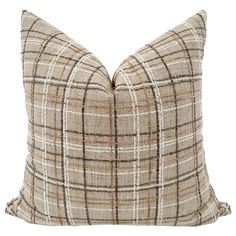 a brown and white plaid pillow on a white background