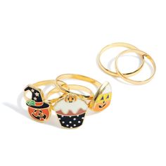 three rings with different designs on them and one has a pumpkin, cupcake, witch hat