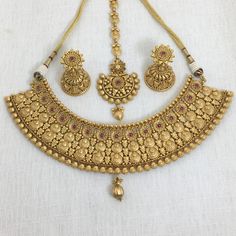 India Gold Necklace, a dazzling piece of Temple Jewelry. This Choker Necklace exudes timeless elegance and is ideal for weddings and special occasions. Crafted in the South Indian tradition, it reflects the rich heritage of Temple Jewelry. Adorn yourself with the intricate designs of this Temple Necklace Set, perfect for making a statement. Whether it's a wedding or a grand celebration, this piece adds a touch of sophistication to your ensemble. *𝐏𝐑𝐎𝐃𝐔𝐂𝐓 𝐃𝐄𝐓𝐀𝐈𝐋* * Material: Brass * Luxury Gold Plated Bollywood Temple Necklace, Luxury Brass Temple Necklace For Ceremonial Occasions, Classic Gold Bridal Necklace With Elegant Design, Gold Temple Jewelry Bridal Accessories, Gold Bridal Necklace With Elegant Design For Wedding, Wedding Bridal Sets In Temple Jewelry Style, Classic Gold Bridal Sets For Wedding, Classic Gold Bridal Necklace For Wedding, Intricate Bridal Necklace For Wedding