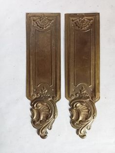 pair of ornate brass wall sconces on white background