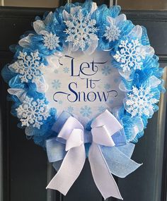 a blue and white wreath that says let it snow