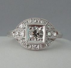 Absolutely gorgeous vintage Art Deco diamond engagement ring that has been completely restored to like new condition, including fresh rhodium dipping. Gia Certified Art Deco Diamond White Rings, Gia Certified Diamond White Art Deco Rings, Antique Brilliant Cut Diamond White Diamond Ring, Antique Brilliant Cut Diamond White Ring, Antique Diamond White Diamond Ring With Brilliant Cut, Antique Diamond Ring With Center Stone, Silver Art Deco Diamond Ring Gia Certified, Classic Halo Ring With Cushion Cut Diamond, Classic Cushion Cut Halo Ring With Diamond Detail