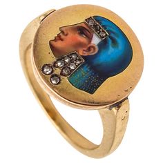 An Egyptian revival ring. Magnificent antique 19th century ring, created in Europe in the Egyptian revival style, back in the 1860's. The outstanding ring has been crafted with classic patterns in solid yellow gold of 14 karats with high polished finish. The main decorative element is the elegant portrait in profile of an Egyptian queen facing to the left and wearing diamond's jewelry such, dangle earrings and a tiara. The queen's portrait is decorated with the difficult polychrome enamel techni Antique Yellow Gold Enamel Ring, Antique Enamel Rings For Formal Occasions, Antique Hallmarked Enamel Wedding Ring, Victorian Enamel Wedding Ring, Vintage Enamel Cabochon Rings, Ceremonial Antique Rings With Antique Finish, Antique Yellow Gold Enamel Ring For Ceremonial Occasions, Antique Yellow Gold Enamel Ring For Ceremonies, Victorian Gold Enamel Ceremonial Ring