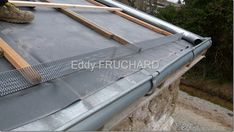 a man working on the roof of a house