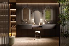 a bathroom with two sinks, mirrors and stools next to a potted plant