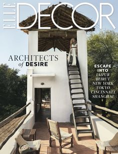 a magazine cover with a woman standing on the top of a building and stairs leading up to it