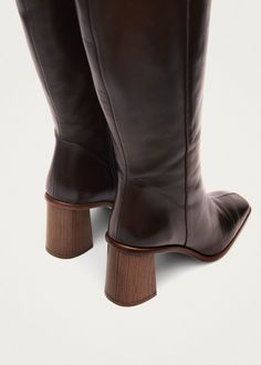 Brown leather knee-high boots with block heel A classic in our collection, the Est boots are shaped from brown leather to a knee-high silhouette, featuring a squared toe and block heel, and benefiting from a functional side-zip fastening Brown Leather Knee High Boots, Brown Knee High Boots, Sustainable Leather, High Knees, Coffee Brown, Brown Leather Boots, Beauty Bag, Tall Boots, Active Wear Tops