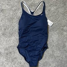 Nike Navy Swimsuit Padded Brand New With Tag Womens M Professional Swimming Suits, Navy Blue One Piece Swimsuit, Navy One-piece Bodysuit For Swimming, Navy One-piece Bodysuit For Pool, Nike Blue Swimwear For Pool, Nike Nylon Swimwear For Sports, Nike Blue Swimwear, Nike Nylon Sports Swimwear, Blue Nylon Sports Bodysuit