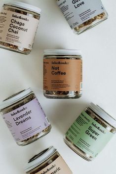 five jars of different types of coffee on a white surface with the words lakeland, chicago, and not lavender dream written in them