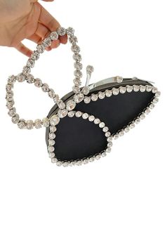 Elevate your style with our Black Butterfly Clutch, adorned with dazzling crystals. This exquisite accessory adds a touch of sophistication to any ensemble, perfect for glamorous evenings, cocktail parties, and formal affairs. Chic Metal Jewelry For Evening, Chic Metal Evening Jewelry, Chic Evening Metal Jewelry, Trendy Sparkling Jewelry For Party, Sparkling Jewelry For Night Out, Chic Crystal Jewelry For Evening, Trendy Rhinestone Jewelry For Formal Occasions, Embellished Metal Jewelry For Formal Occasions, Trendy Formal Jewelry With Rhinestones