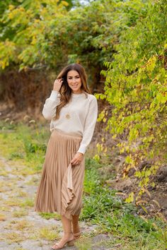 We cannot get over how stylish this skirt is! The cinched waist and accordion accents makes this such a cute, elegant look! Wear this skirt to any event and you are sure to receive compliments! We love tucking a blouse into this for a more elevated look or a basic or graphic tee for a casual feel!97% Polyester & 3% SpandexHand wash cold. Color separate. Do not bleach. Lay flat to dry. Low iron if needed. Spring Night Out Skirt With Elastic Waistband, Skirt With Elastic Waistband For Spring Night Out, Spring Skirt With Elastic Waistband For Night Out, Elastic Waistband Skirt For Spring Night Out, Elegant Beige Tiered Skirt Bottoms, Chic Asymmetrical Pleated Maxi Skirt, Chic Beige Ruffled Skirt Bottoms, Flowy Long Pleated Skirt For Night Out, Elegant Beige Skirt With Elastic Waistband