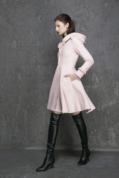 "Keep warm + elegant + stylish in this classic pink wool coat from Xiaolizi. The winter coat made from soft wool material in a fit and flare silhouette. The womens coats topped with a button-down placket + hooded collar. The swing coat finished with ruffle long sleeves + side-entry pockets. ** Detail ** * Wool composition \" 45% wool blend + fiber \" ; An excellent high-quality wool, a beautiful retro wool, The wool itself isn't a thick high end wool but it's very warm and just perfect. Making i Spring Wool Coat With Stand Collar, Elegant Hooded Wool Outerwear, Fitted Long Sweater Coat For Spring, Feminine Fitted Winter Outerwear, Chic Stand Collar Wool Coat For Winter, Chic Wool Coat With Stand Collar For Winter, Fitted Pink Wool Outerwear, Pink Fitted Wool Outerwear, Feminine Winter Workwear Outerwear