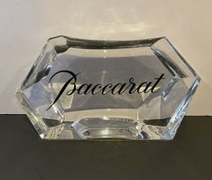 a clear glass award with the word baccarat written in cursive writing