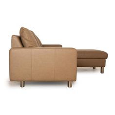 a tan leather reclining chair and footstool sitting next to each other on a white background