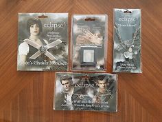 the twilight saga eclipse necklaces and bracelet set in plastic packaging on a wooden table