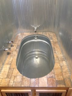 a sink in the middle of a tiled counter top