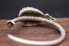 Large Silver ear ornaments. The hoops are made of pearled wire and the bezel is decorated with a large blue Turquoise. Excellent workmanship with a great patina for its age. This is a rare Museum piece. This particular design is worn in pairs by women and single by men from Kham in East Tibet. These pieces might have been handed down to generations. *wear and tear as per age, intact. Combined Weight: 42 grams Ring Size: 48mm Origin: Early 19th c Tibet Traditional Adjustable Hoop Jewelry, Traditional Adjustable Spiral Jewelry, Traditional Spiral Silver Jewelry, Traditional Silver Spiral Jewelry, Traditional Handmade Spiral Jewelry, Traditional Spiral Jewelry For Gifts, Traditional Spiral Metal Jewelry, Traditional Antique Finish Bangle Jewelry, Traditional Hand Forged Jewelry As Gift