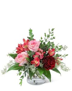 a vase filled with pink and red flowers