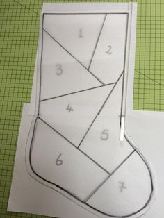 an origami christmas stocking is cut out and placed on a cutting mat