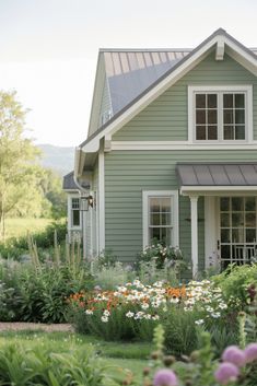 a house with lots of flowers in front of it