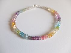 This rainbow bracelet has a great variety of natural gemstones. They are : Aquamarine, , Amethyst, Iolite, Peridot, Citrine, Apatite , clear quartz , pink tourmaline, iolite, Apatite A gorgeous fusion of colors in this multi stone precious bracelet. A riot of pastel colors in ombre design I chose and lined the gemstones to obtain this unique shaded colorful precious bracelet. It will be beautiful alone or together with other gemstones stacking bracelets The gemstone beads are strung on the highe Rainbow Gemstone Beads Bracelet, Rainbow Bracelet Jewelry For Healing, Dainty Multicolor Gemstone Bracelet, Rainbow Gemstone Beads Bracelets For Jewelry Making, Ombre Design, Quartz Pink, Stacking Bracelets, Rainbow Gemstones, Rainbow Bracelet