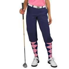 a woman in pink shirt and blue pants holding a golf club