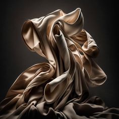 an image of a woman's dress blowing in the wind on a black background