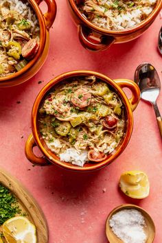 three bowls filled with food on top of a pink table