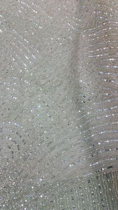 Hand beaded elegantly Beading and Rhinestones. This gorgeous sheer dress Fabric creating a very detailed design. This piece is absolutely stunning and Perfect for your special day! This is not a finished dress; this is a Fabric that can be turned into a garment. This special hand beaded sequenced fabric is made in India by the professionals. It is one of its kind and you can make beautiful dresses, gown, blouses and many more items. Fabrics are sold by length. The prices are for one yard. If you Elegant Bedazzled Sequin Fabric For Party, Elegant Party Sequin Fabric, Elegant Beaded Sequin Fabric For Wedding, White Glamorous Sequin Fabric With Rhinestones, Glamorous White Sequin Fabric With Rhinestones, White Sparkling Sequin Fabric For Evening, Elegant Silver Sequin Fabric With Rhinestones, White Sparkling Sequin Fabric For Glamorous Style, Elegant Pearl Embroidered Sequin Fabric For Party