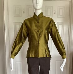 "Romeo Gigli in the early 1990s designed for Callaghan using the same elegant fabrics that he used in his own line.  This blouse is 109% silk shantung.  From my private Romeo Gigli collection. Unworn. Pristine.  Size I44, USA8 Mandarine collar.  Long sleeves.  Made in Italy Excellent workmanship. Made by Zamasport, the same factory in Italy that made his own line.  Finished interior seams. No raw edges.  Front button closure.  Side seam slits. Asian feel to this blouse.  Double pleats at the cuf Designer Long Sleeve Green Tops, Designer Green Long Sleeve Tops, Designer Fitted Long Sleeve Blouse, Fall Blouse With Stand Collar, Classic Stand Collar Blouse For Fall, Green Stand Collar Tops For Fall, Green Stand Collar Top For Fall, Green Fitted Top For Formal Occasions, Fitted Green Top For Formal Occasions