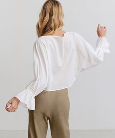 Cape Blouse IvoryFloaty and refined, this sheer statement top styles well with a tank, cami, or bralette—and pairs perfectly with every best-dressed occasion. Made in China of Italian fabric. 88% cotton, 12% linen. Boxy blouse with gathered sleeves. | Jenni Kayne Women's Cape Blouse Size 2X-Large Summer Crop Top With Blouson Sleeves, Feminine Linen V-neck Blouse, Summer Fitted Crop Top With Blouson Sleeves, Fitted Crop Top With Blouson Sleeves For Summer, Effortless V-neck Top For Daywear, Chic Summer Blouse For Brunch, Effortless Summer Crop Top, Fitted Chic Linen Blouse, Chic Fitted Linen Blouse