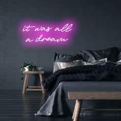 there is a neon sign that says it was all a dream on the wall above the bed