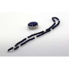 This is part of Chairish’s Fine Jewelry assortment.  LENGTH: 18″ chain, 22″ with pendant DIMENSIONS: Pendant is 30mm x 30mm STONES: Lapis lazuli beads, 4.5mm STONES: Diamonds, 2 ct surround, .8 ct accents, clarity SI1, color G, total 2.8 cts METAL: 18k white gold CONDITION: New  Lapis & Diamond Pendant 18K Beaded Lapis Chain. This extra fine quality lapis lazuli pendant is 25mm in a 30mm 2 carat diamond surround mount. Also, the 4.5mm lapis beads are strung on an 18k white gold chain, which is s Luxury Oval Lapis Lazuli Jewelry, Sapphire Single Strand Necklace In Lapis Lazuli, Sapphire Colored Lapis Lazuli Single Strand Necklace, Elegant Blue Oval Beads Jewelry, Sapphire Color Lapis Lazuli Necklace, Elegant Blue Oval Beaded Jewelry, Luxury Sterling Silver Necklace With Polished Beads, Elegant Blue Beads Gems And Cabochons For Gifts, Elegant Pendant Jewelry With Spacer Beads