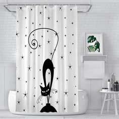 a black and white shower curtain with an image of a cat on it's head