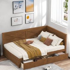 a bed with drawers underneath it in a room