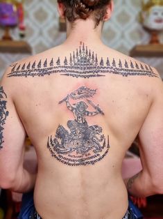 a man with a tattoo on his back