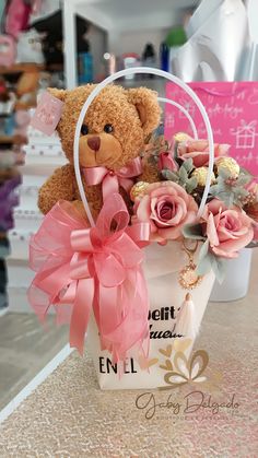 a teddy bear sitting in a basket filled with flowers