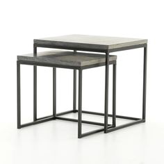 a set of three nesting tables with metal frames and concrete top, on a white background