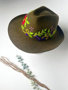 Feel the Andean spirit with this soft wool hat, handcrafted in fedora style with structured top and wide brim and features unique floral embroidery designs. Handcrafted by an artisan family in Pisaq, Peru the Blooming Fedora hat is just a fabulous piece with much character and tradition. Our partner Margarita creates the floral designs and embroiders them using alpaca yarns. Details  100% wool felt Alpaca threads on the floral embroidery Due to the natural dyes and handmade nature slight variati Felt Alpaca, Floral Embroidery Designs, Fedora Style, Embroidery Hat, Structured Top, Floral Hat, Hat Embroidery, Alpaca Yarn, Beading Ideas