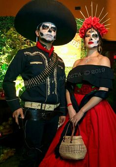 a man and woman in costumes standing next to each other wearing mexican makeup for the day of the dead