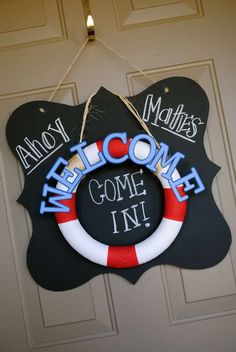 a welcome sign hanging on the front door to someone's home in town, michigan