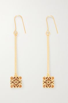 Loewe's 'Anagram' motif adorns many of the brand's designs, from its signature leather bags to smaller accessories like these earrings. They're made from glossy gold-plated silver with three-dimensional logo charms suspended from fine ball chains. Designer Gold-tone Earrings As Gift, Luxury Metal Dangle Earrings, Designer Gold-tone Earrings For Formal Occasions, Elegant Gold-tone Linear Earrings, Luxury Single Dangle Earring, Luxury Linear Evening Earrings, Luxury Single Linear Earring For Evening, Luxury Metal Drop Earrings, Designer Dangle Earrings For Gift