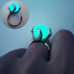 an image of a ring that is on someone's foot with the light green stone