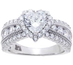 a heart shaped diamond ring with two rows of diamonds on the band and an oval center stone