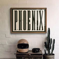 a white brick wall with a sign that says phoenx and a helmet on top