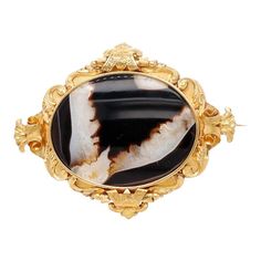 This is part of Chairish’s Fine Jewelry assortment.  A fine antique Victorian brooch.  In 18k gold.  With a large bezel-set oval banded agate specimen in an ornate scrolling frame with etched decoration.  Simply a wonderful Victorian Period brooch!  Date: 1860s to 1870s  Overall Condition: It is in overall good, as-pictured, used estate condition.  Condition Details: There is a small fissure to the agate at about 4 o'clock on the dial and some light surface scratches. There are some light dings & indentations here and there, and other signs of wear. Otherwise, there are some fine & light surface scratches and other signs of expected light wear consistent with age.  Fineness: Unmarked for gold fineness. Professionally tests at 18k  Gemstone Measurements: 1 Banded Agate: ca. 46mm x 35mm  Mea Victorian Brooch, Victorian Period, Antique Brooches, Banded Agate, Antique Victorian, Bezel Setting, Gold Bands, Agate, 18k Gold