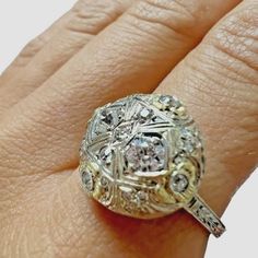 14kt White And Yellow Gold Vintage European Cut Diamond Dome Ring. There Are Two 3.5mm Old Euro Cut Diamonds And 19 Other Old Euro Cut Diamonds On The Ring. The Ring Is Approximately 0.54ctw Of Diamonds (Estimated In Ring). All Diamonds Are Estimated To Be Vs2-Si1 In Clarity And G-H In Color. The Sphere Of The Ring Measures Approximately 15mm In Diameter And Is Raised Approximately 4.59mm High. This Is An Elegant Vintage Engagement Ring Or Cocktail Ring. The Ring Is Size 7.75 And Weighs 4.1grams Platinum Jewelry With Single Cut Diamonds In Gold, Platinum Jewelry With Gold Single Cut Diamonds, Gold Platinum Jewelry With Single Cut Diamonds, Yellow Single Cut Diamond Rings For Anniversary, Yellow Rings With Single Cut Diamonds For Anniversary, Gold Cluster Ring With Brilliant Cut In Platinum, Yellow Gold Platinum Diamond Ring With Rose Cut Diamonds, Yellow Gold Platinum Diamond Ring With Rose Cut, Gold Platinum Diamond Ring With Rose Cut Diamonds