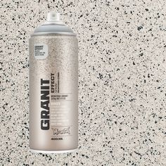 a can of gray spray paint sitting on top of a white countertop with black speckles