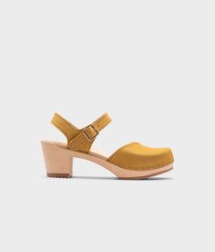 high-heeled clog sandals with a closed toe in yellow leather stapled on a light wooden base Royal Yellow, Cork Sandals, Wooden Clogs, Clog Sandals, For A Reason, Boot Shop, Shop Sandals, Step Up, The Struts